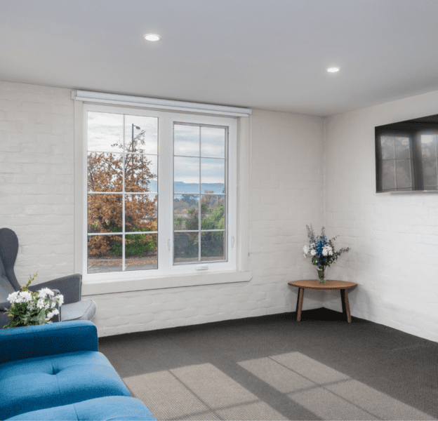 2-Bedroom Guest Room living room area with mounted TV