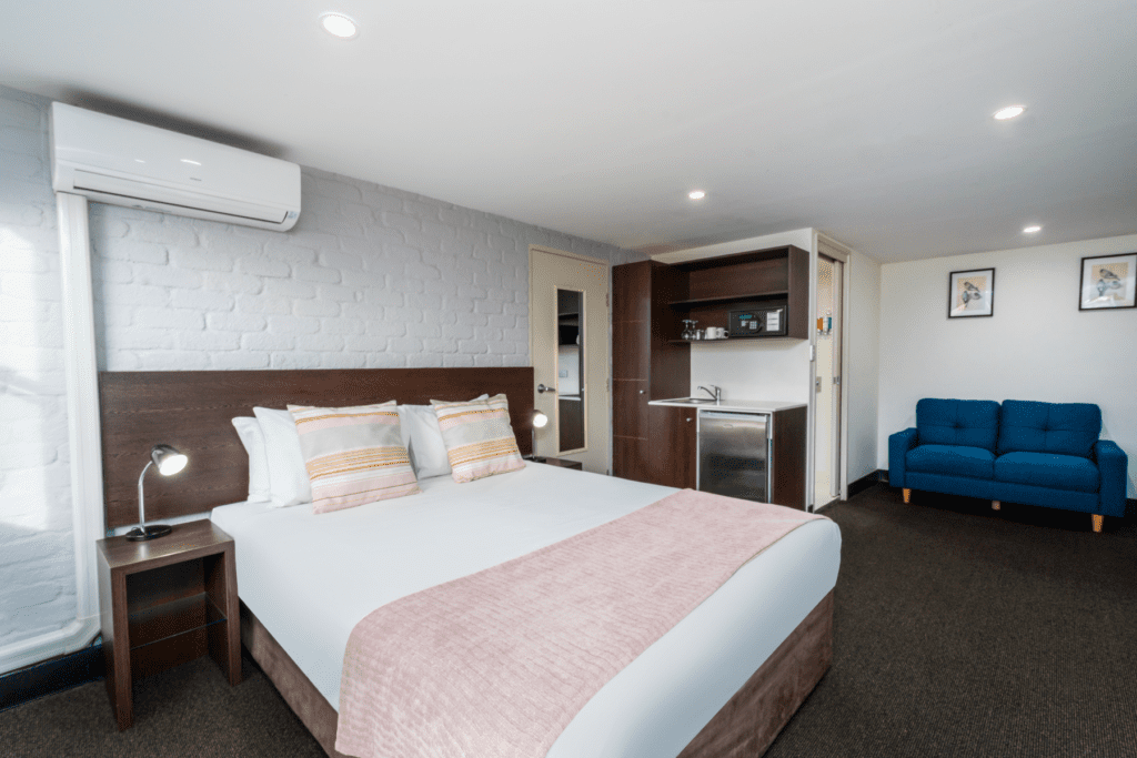 Standard Queen room with bed, kitchenette & sofa