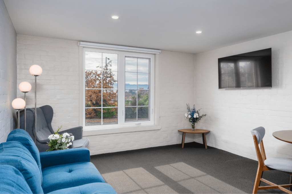 2-Bedroom Guest Room living room area with mounted TV