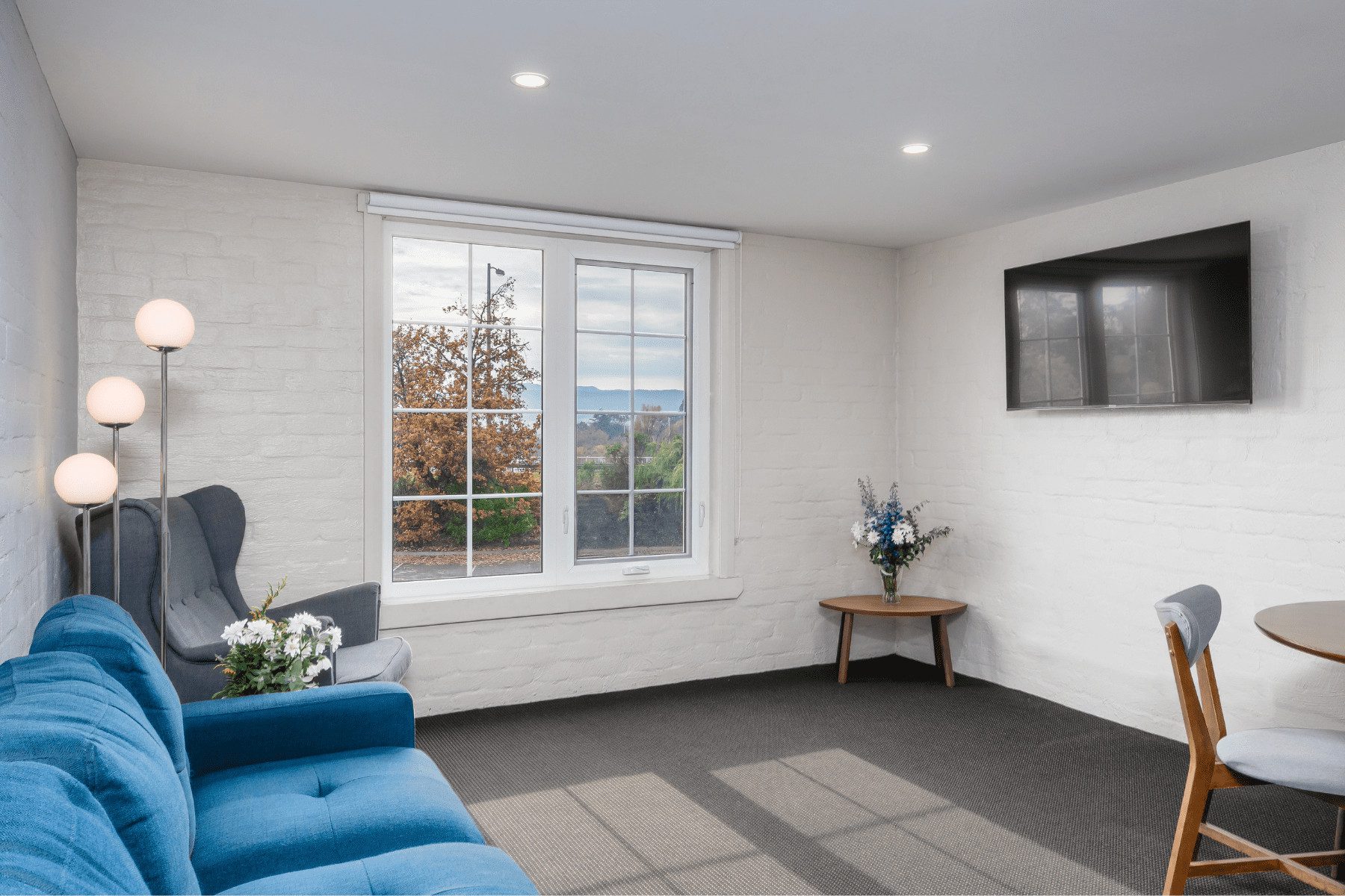 2-Bedroom Guest Room living room area with mounted TV