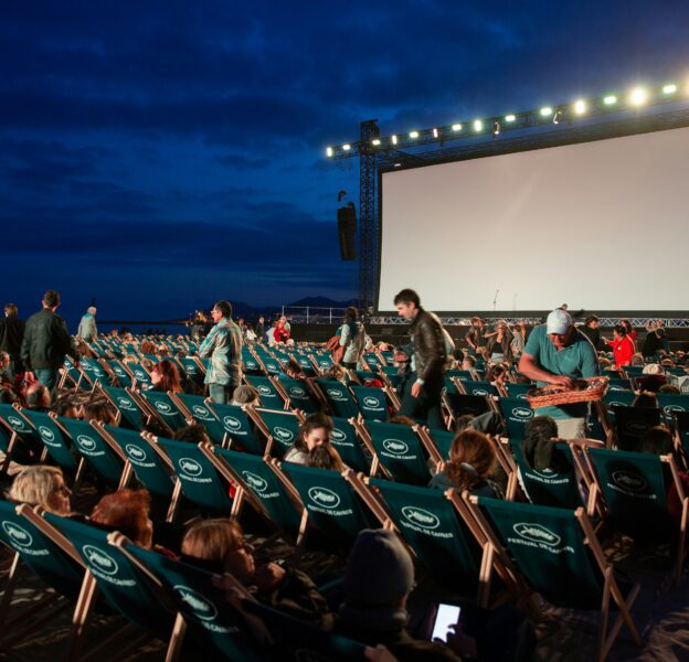 The image of the outdoor cinema setup at night
